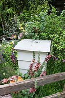 Chelsea Flower Show, 2009. The Fenland Alchemist Garden ( des. Hall and Besser ) beehive in informal cottage garden