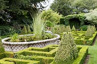 Bourton House Garden, Gloucestershire. Mid summer. The formal knot garden with 'Basket' pond