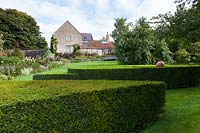 Derry Watkins Garden at Special Plants, Bath, UK Clipped Yew hedging with large lawned area