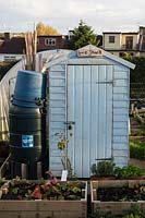 blue painted allotment shed with sign saying 'Love Shack'