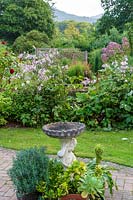 Jackie Healy's garden near Chepstow. Early autumn garden. Bird bath and potted plants