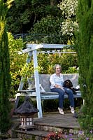Jackie Healy's garden near Chepstow. Early autumn garden.  The swing bench