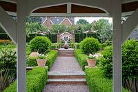 Mitton Manor, Staffordshire. Formal garden parterre with Neil Wilkin glass 'Suncatcher' sculptures