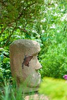 Sheila White's garden, Queens Gate, Bristol, UK. 'Easter Island' 'head' sculpture