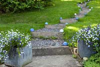 Carole Waller's garden at Bathford, Somerset, summer.  Containers and pots in small garden