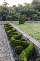 Shaped hedging and topiary at Barbara Stockitts garden at West Kington, Wiltshire