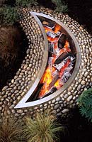 private garden Hampshire design Pamela Woods crescent moon shaped fire pit with pebbles
