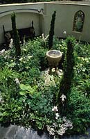 Chelsea 1998 Design Fiona Lawrenson Overview of circular white garden with water feature as focal point and Buxus Greenpeace