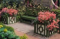 Chelsea FS 1991 Green wooden bench with pink Pelargoniums in Versailles tubs
