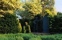 Tilford Cottage Surrey Lonicera nitida topiary figure Yew hedge Acer drummondii gate