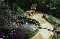 Feng Shui garden London Design Pamela Woods cool colour area circular pond with statue fountain curved sinuous cobble path decki
