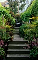 private town garden San Francisco California Design Chris Jacobsen raised wooden decking with steps table and chairs in secluded