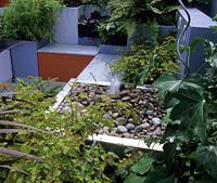 Chelsea FS 2002 design Nathalie Charles colourful contemporary roof garden with formal stainless steel pebble water feature