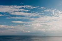 blue sky white cloud seasxape small islands Mediterranean Greece sun sunlight sunlit day view water calm still sunny