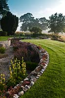 contemporary sunken garden stone walls retaining designer design Julie Toll curved circular sinuous patio summer perennials tree