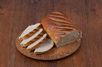 Bloomers white brown wholemeal local fresh loaf bread hand made edible kitchen food breadboard table still life sliced slices