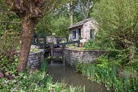 Canal lock and lock keeper's cottage with native flora including red campion and willow, The Welcome to Yorkshire Garden, Design: Mark Gregory, Sponsor: Welcome to Yorkshire, Gold Medal Winner