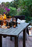 Garden furniture on terrace, set up with candles and mugs, Le Mas de BÃ©ty, France. 