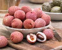 Litchi chinensis - lychee, cut open to show white flesh and stone