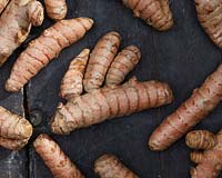 Curcuma longa, Turmeric on dark surface. 