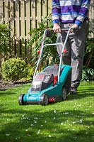 Mowing the lawn with a rechargeable lawnmower 