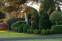 View of formal topiary garden and statue at Brodsworth hall, Yorkshire.