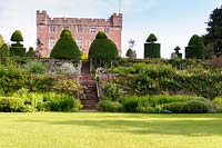 Ancient clipped yew topiary dominates the sequence of terraces between upper and lower gardens, Askham Hall, near Penrith, Cumbria. 