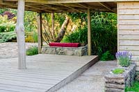A view of decked area and sheltered outdoor seating area, Lower Treculliacks Farm, Falmouth, Cornwall, UK.
