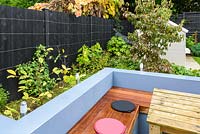 Built in garden seating is surrounded by mixed planting. 
