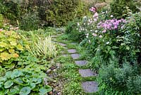 A path made of stepping stones in NGS garden in St Albans, Hertfordshire, UK.