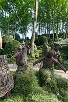 Figures by Agneska Gradzik with Muehlenbeckia complexa ground cover. Les Jardins D'Etretat. Les Jardins D'etretat, Normandy, France.
