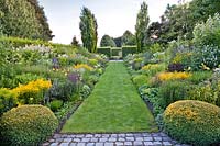 Long garden room with double mixed borders and lawn path, Laura Dingemans garden, Netherlands.