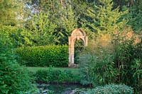 Monumental archway with bamboos and Nuphar lutea- native waterlilies 