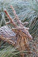 Woven deer garden ornament in frost. 