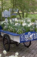 Old Delts blue decorated carriage filled with Muscari and Narcissus. 