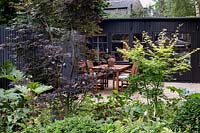 Summer house with Acer palmatum 'Blood good' and Acer palmatum 'Katsura'