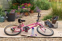 Painted childs bike with baskets for bedding plants