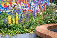 Raised beds with colourful planting. The Supershoes, Laced with Hope Garden, a partnership with Frosts. Sponsor: Frosts Garden Centres, RHS Chelsea Flower Show, 2018.