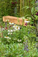Wooden bench surrounded by perennials - Secured by Design, Sponsored by Secured By Design, Capel Manor College, Smartwater, RHS Hampton Court Flower Show, 2018.