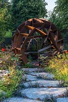 Corten steel sphere by William Roobrouck - Elements Mystique Garden, Sponsored by Elements Garden Design, RHS Hampton Court Palace Flower Show, 2018. 