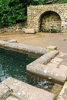 Plunge Pool and stone arch. Painswick Rococo Garden, Gloucestershire, UK
