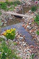 Recycled  bricks beside shallow stream. Finding Urban Nature Garden, RHS Tatton Park
