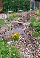 Recycled bricks beside shallow stream. Finding Urban Nature Garden, RHS Tatton Park Show, 2018. 
