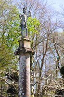 Statue of Roman soldier stands atop an ionic column surveying the landscape beyond. Plas Brondanw, Penrhyndeudraeth, Gwynedd, Wales