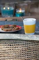 View of coffee and bread in cosy outdoor seating area modern garden. 