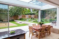 View from the dining room out to the patio and garden. Garden designed by Peter Reader Landscapes.