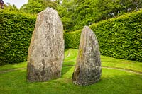 Delabole slate standing stones within a Hornbeam hedge enclosure. Plaz Metaxu Garden, Devon, UK.