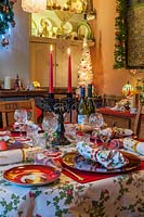 View of decorated dining table set for Christmas dinner. 