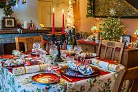 View of decorated dining table set for Christmas dinner.