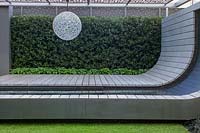Contemporary and dramatic curving deck with ornamental sphere. RHS Chelsea Flower Show 2005, London, UK. 